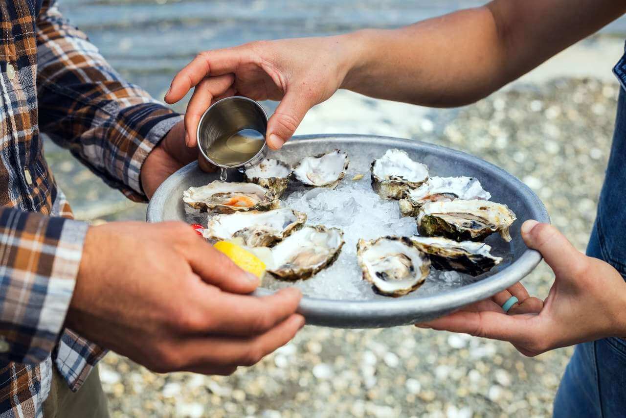 Photo of couple enjoying oysters on the Olympic Peninsula. 
