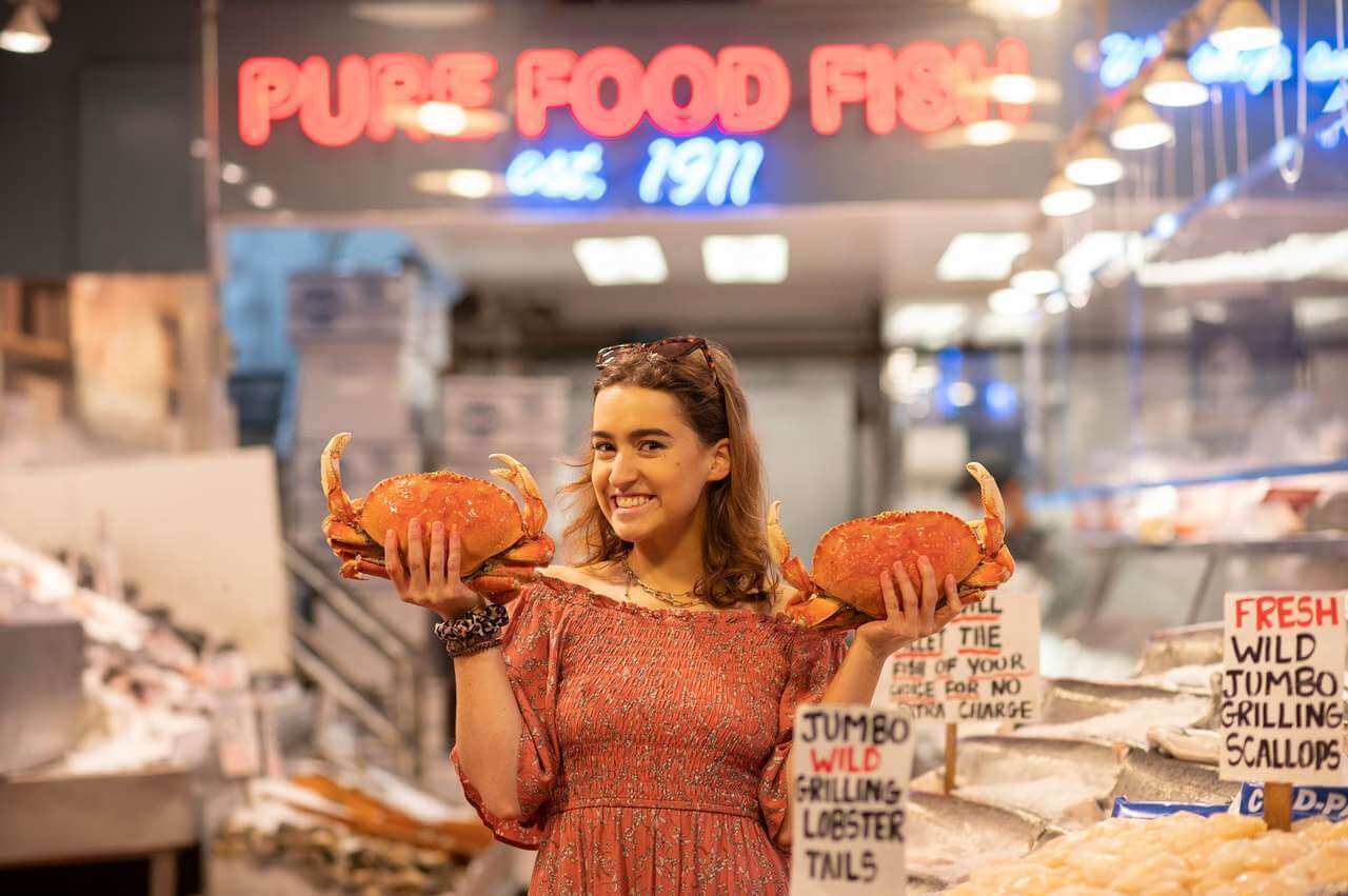 Photo of woman holding crabs at Pike Place Market