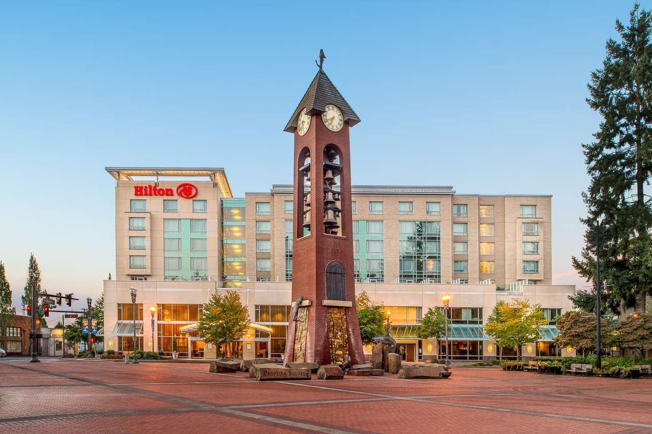 Exterior view of the Hilton with a clock tower in the foreground