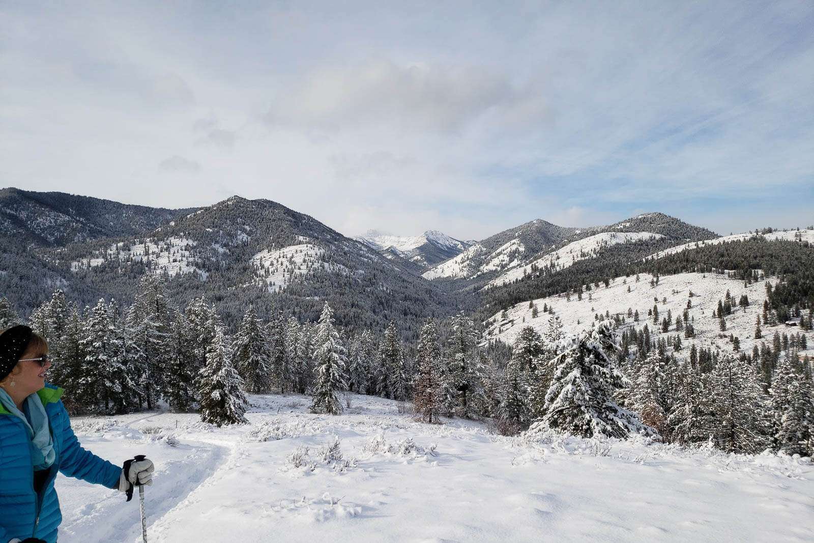 Woman snowshoes along a trail at Sun Mountain Lodge