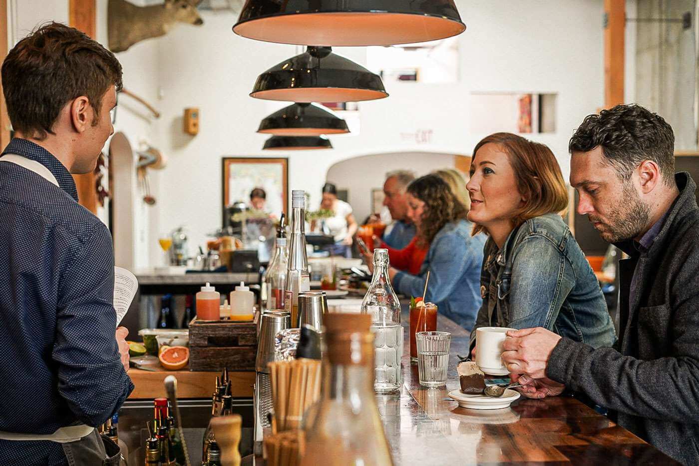 Men and women sit at the bar at a restaurant in Walla Walla