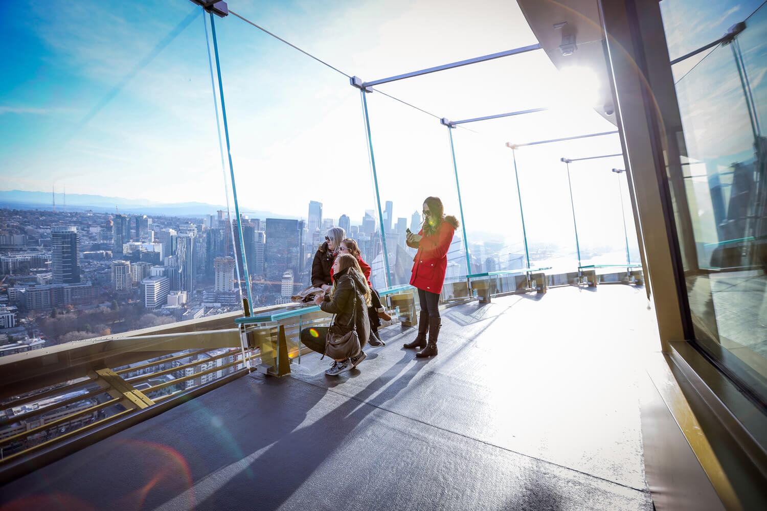 A group of women take in the view of Seattle from the deck of the Space Needle.