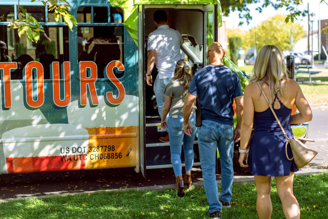 A group gets on a tour bus for beer tasting.