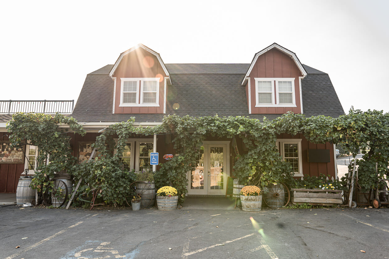 Exterior of a barn with vines.