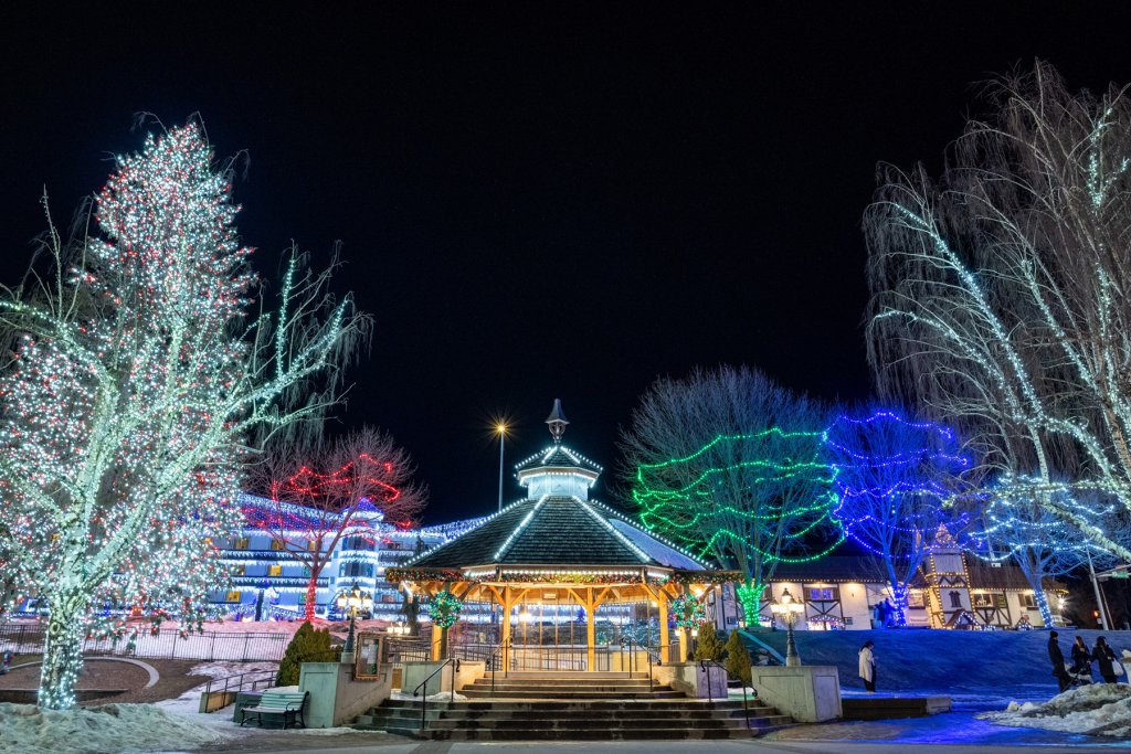 Downtown Leavenworth at night is decked out in holiday lights and dusted with snow.