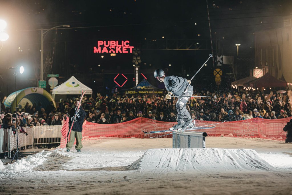 A skier grinds on a railing in front of a crowd during the Rails and Ales event, one of many things to do in Wenatchee.