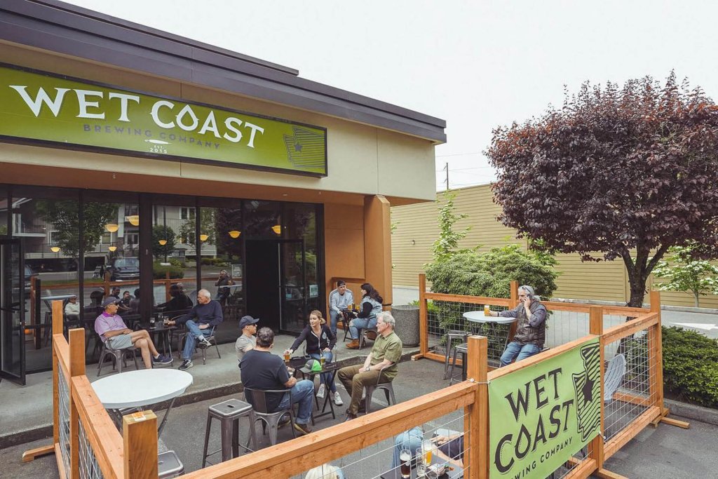 Customers sit at outdoor tables at Wet Coast.