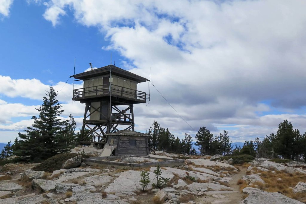 The Mount Bonaparte Fire Lookout Tower perches atop a rocky mountain.