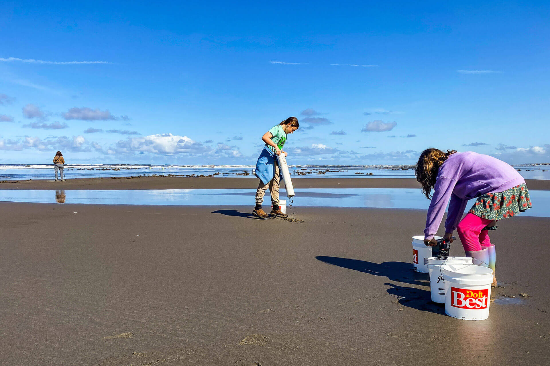 Two children dig for clams in Long Beach Washington