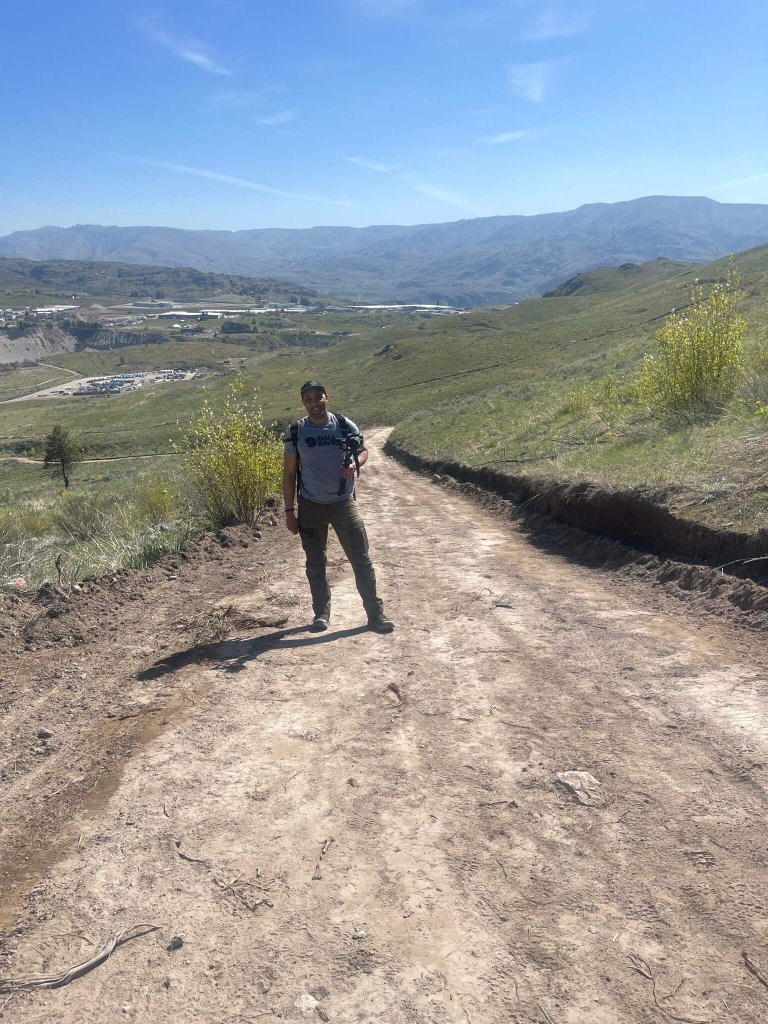 Anthony Love poses for a photo on a trail overlooking Chelan