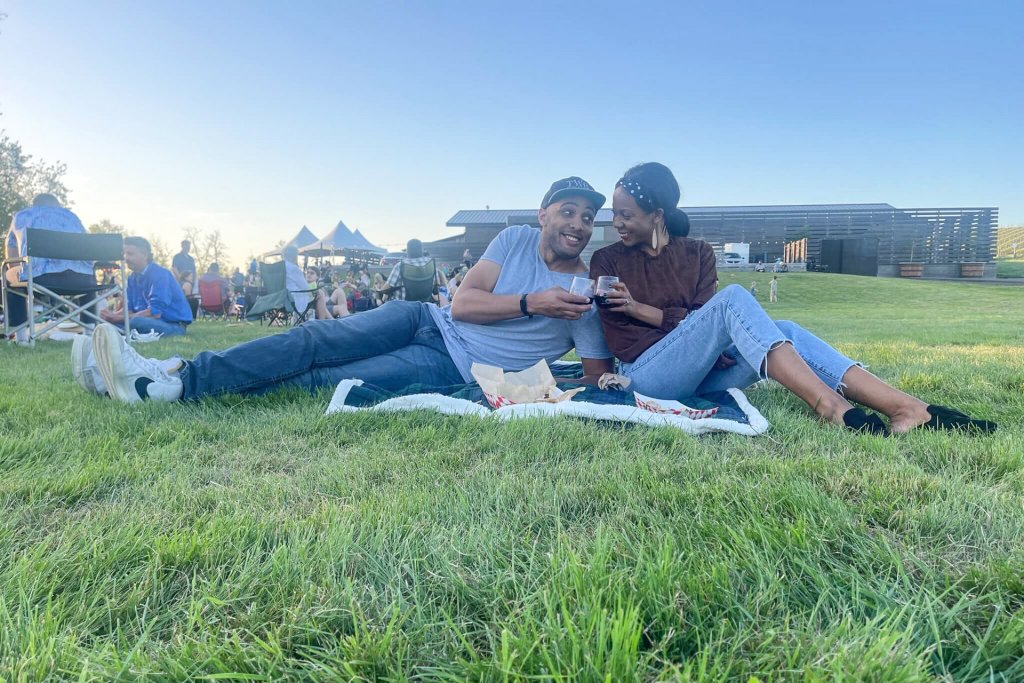Anthony and Marlie Love sip wine in the grass in Walla Walla, one of the destinations they enjoyed visiting as Black travelers in Washington