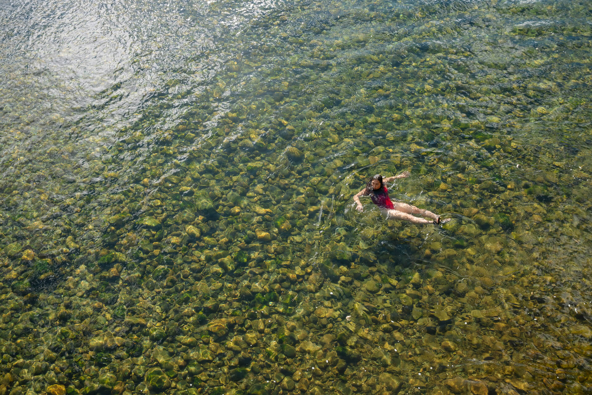 A woman enjoys swimming in the Methow River in Washington.