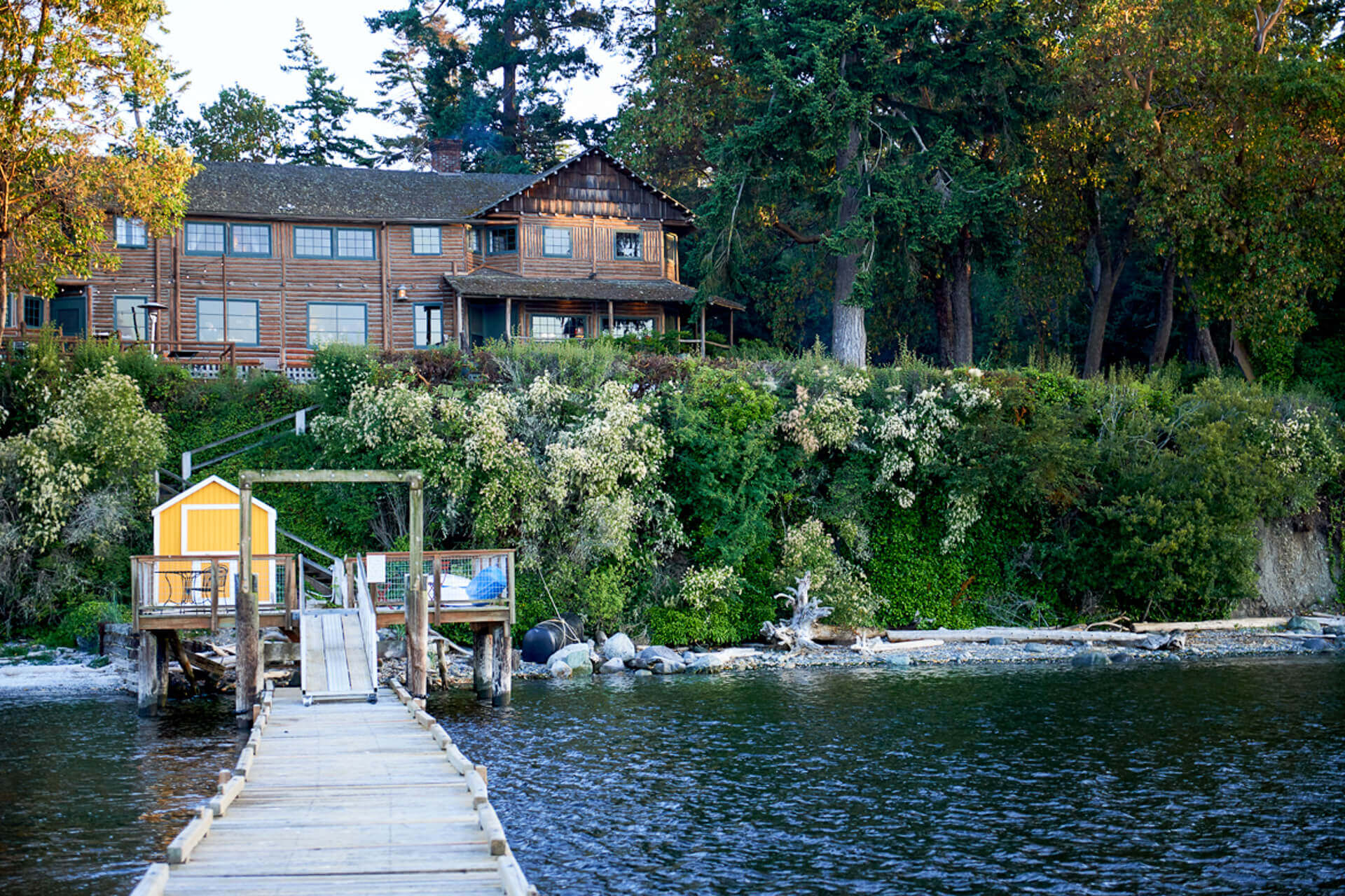 Exterior view of Captain Whidbey near Deception Pass. Shows a dock and water.