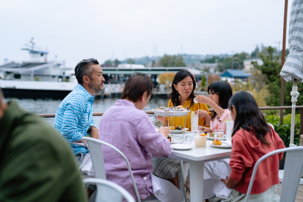 A family enjoys dinner together on the outside patio at Westward in Seattle. 