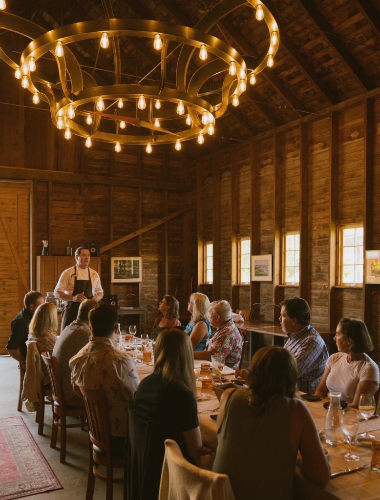 Guests dining in the historic barn dining room at Orchard Kitchen on Whidbey Island. 