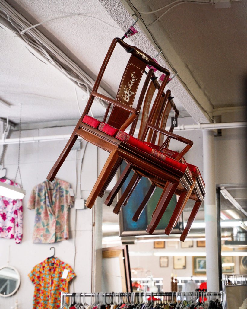 Antique chairs hang from the ceiling inside House of Vintage in Vancouver.