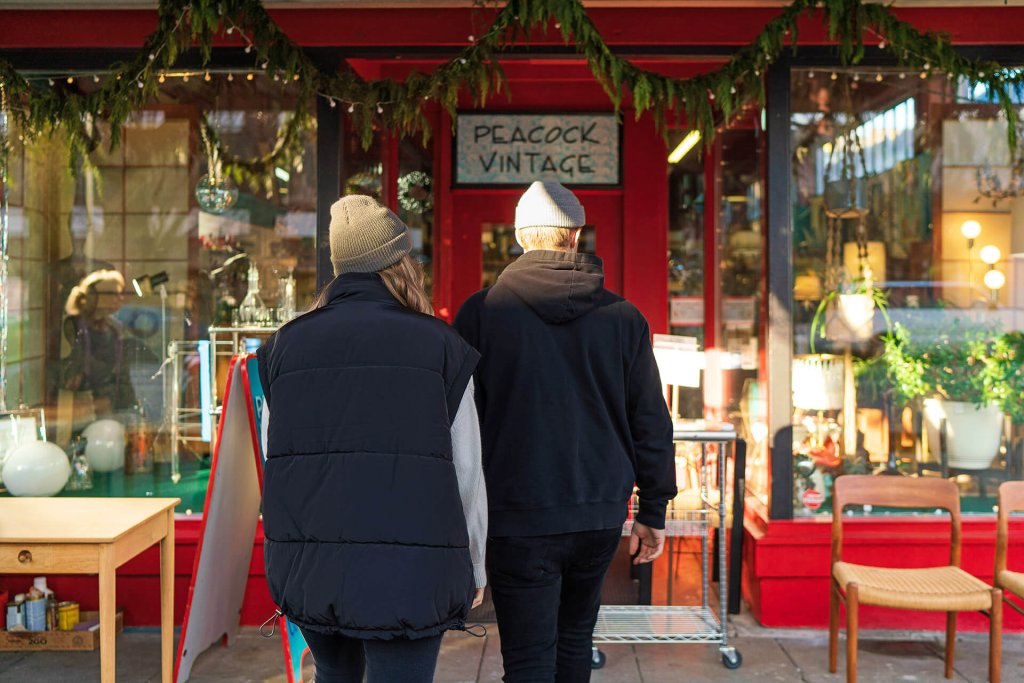A man and woman walk toward the front door of Peacock Vintage, and antiques shop in Washington.