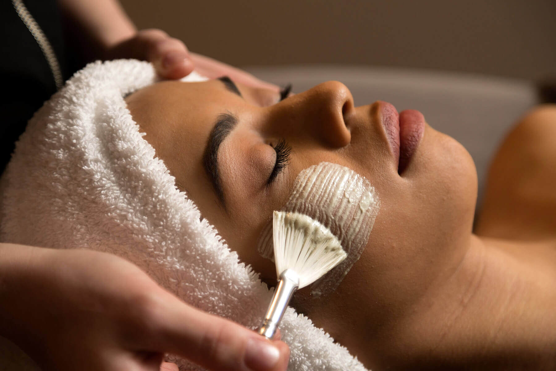 Woman receiving a facial at the spa in Willows Lodge. 