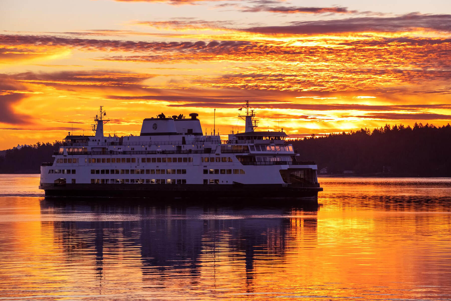 A ferry travels to the San Juan Islands at sunset. 
