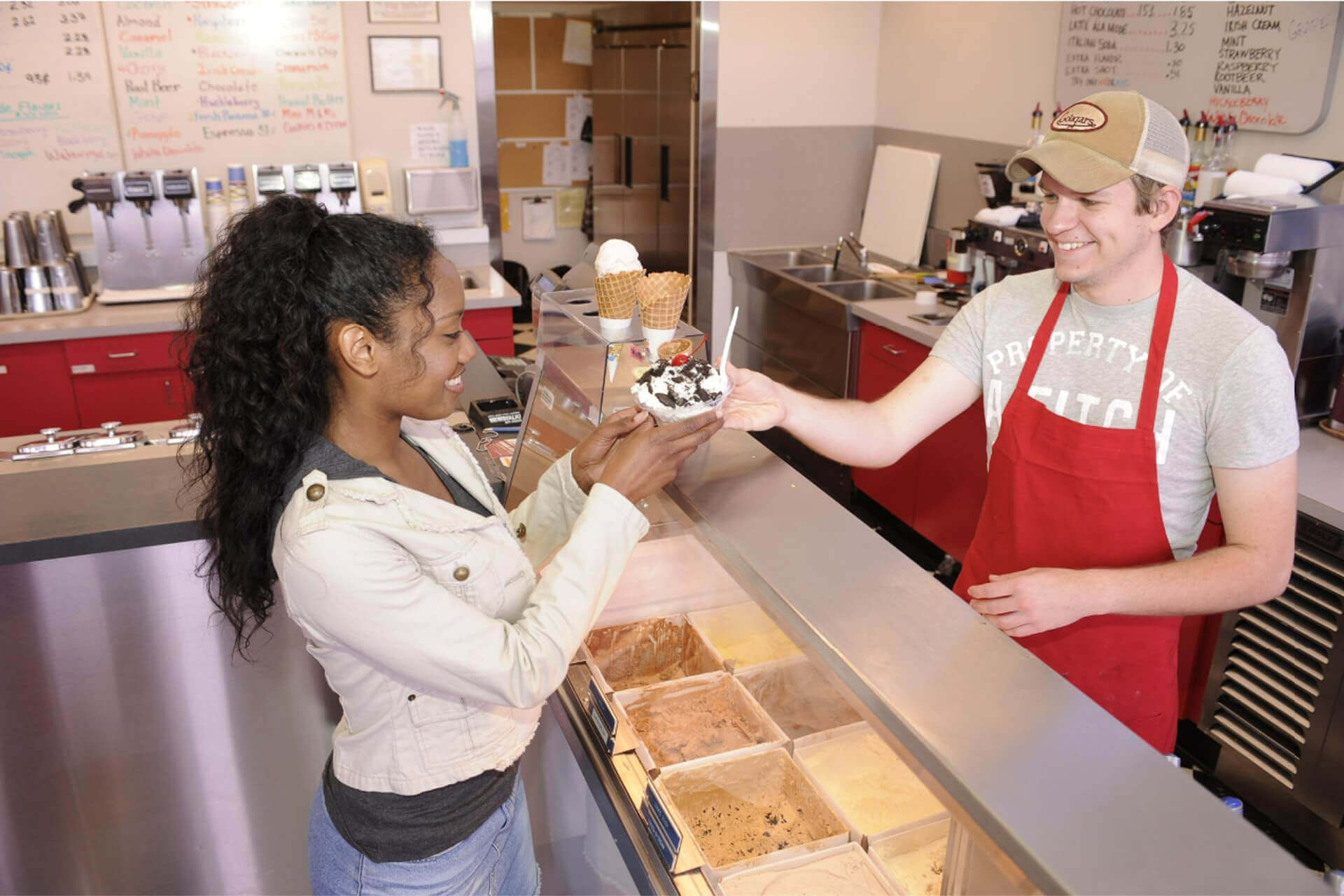 A server hands a customer a scoop of ice cream at Ferdinand's