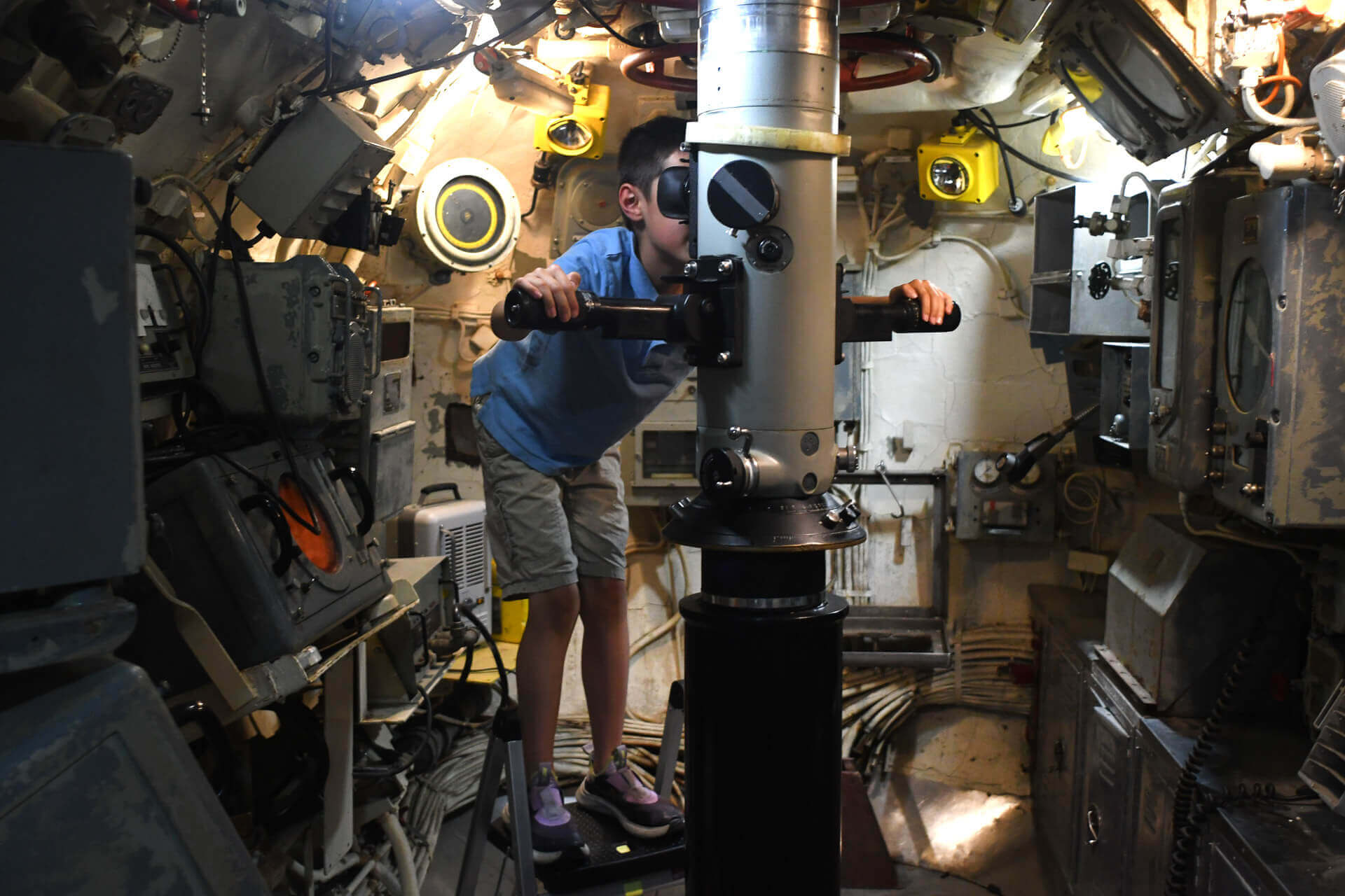 A young boy looks through a periscop inside part of a decommissioned submarine in Richland.