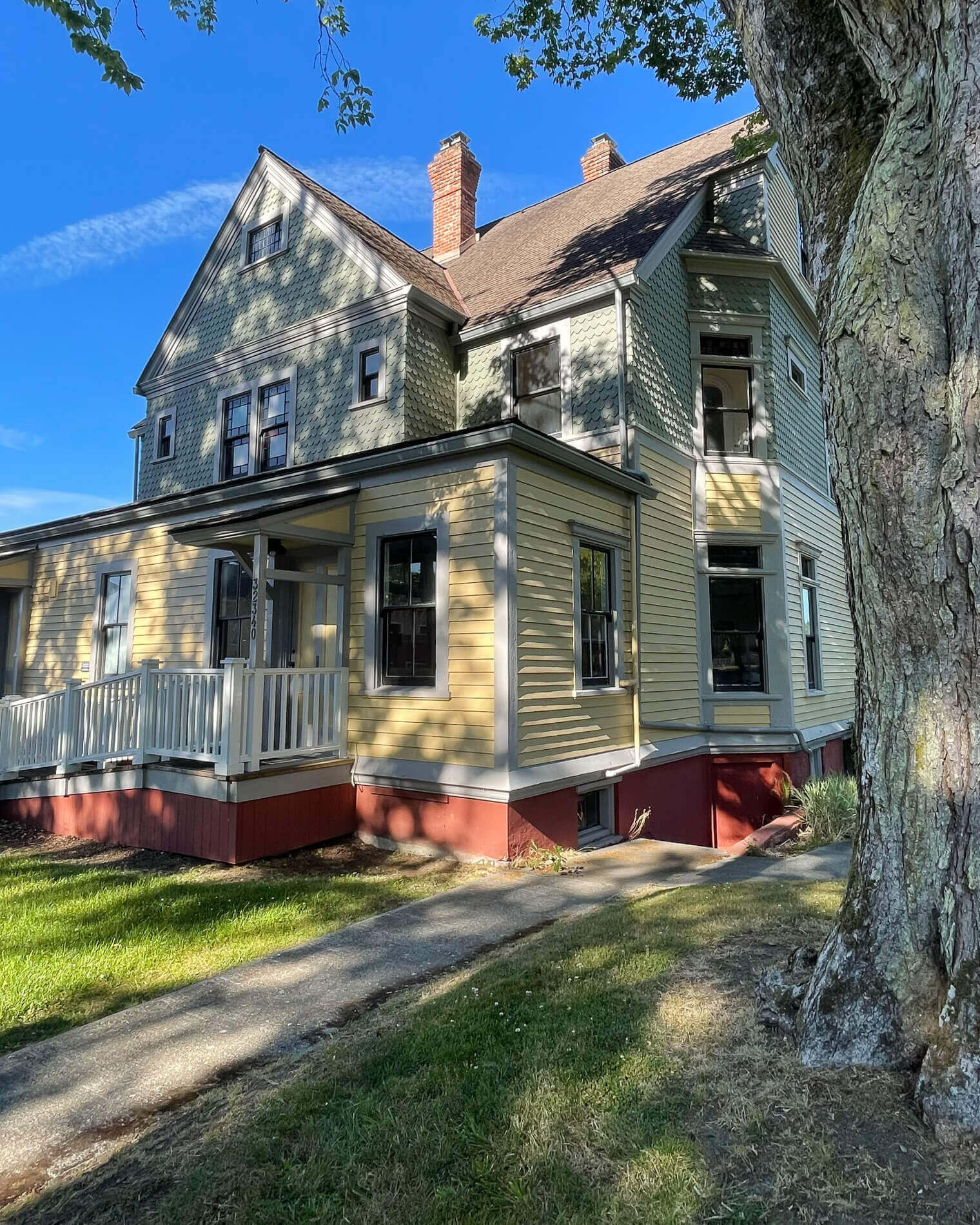 Photo of the exterior of a two-story house in Port Gamble, one of many supposedly haunted places in Washington State.