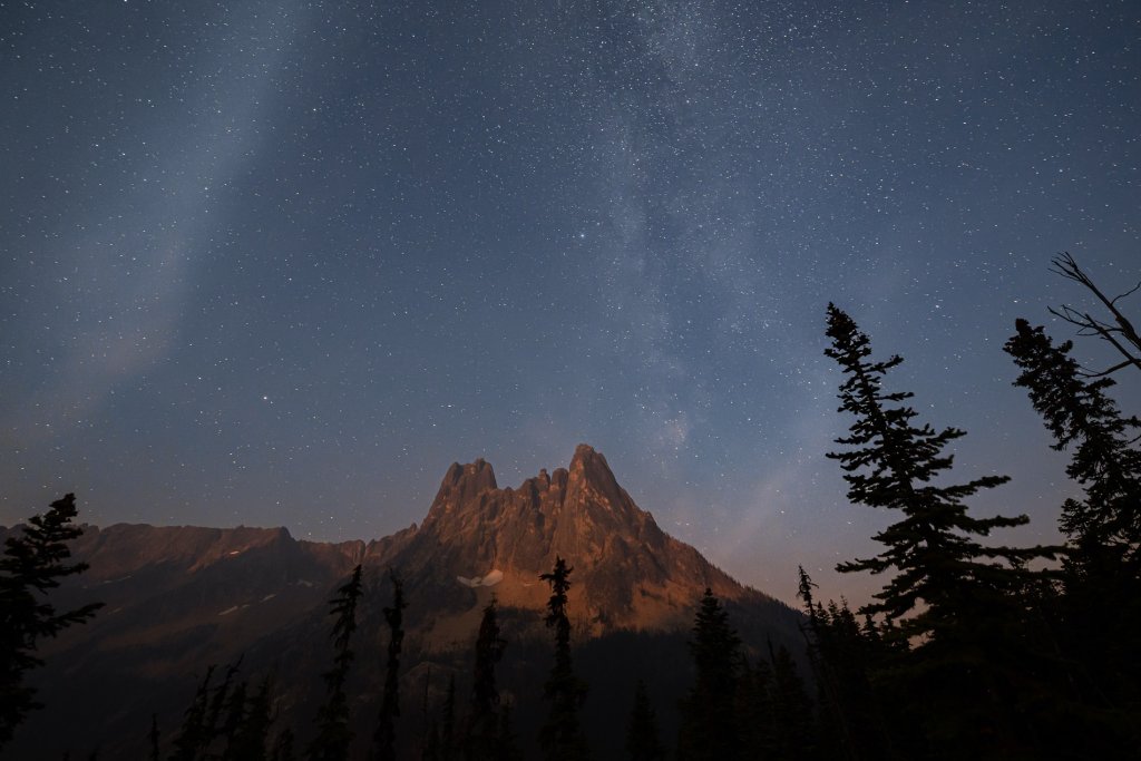 Photo of a mountain peak silhouetted against a starry sky in Washington State.