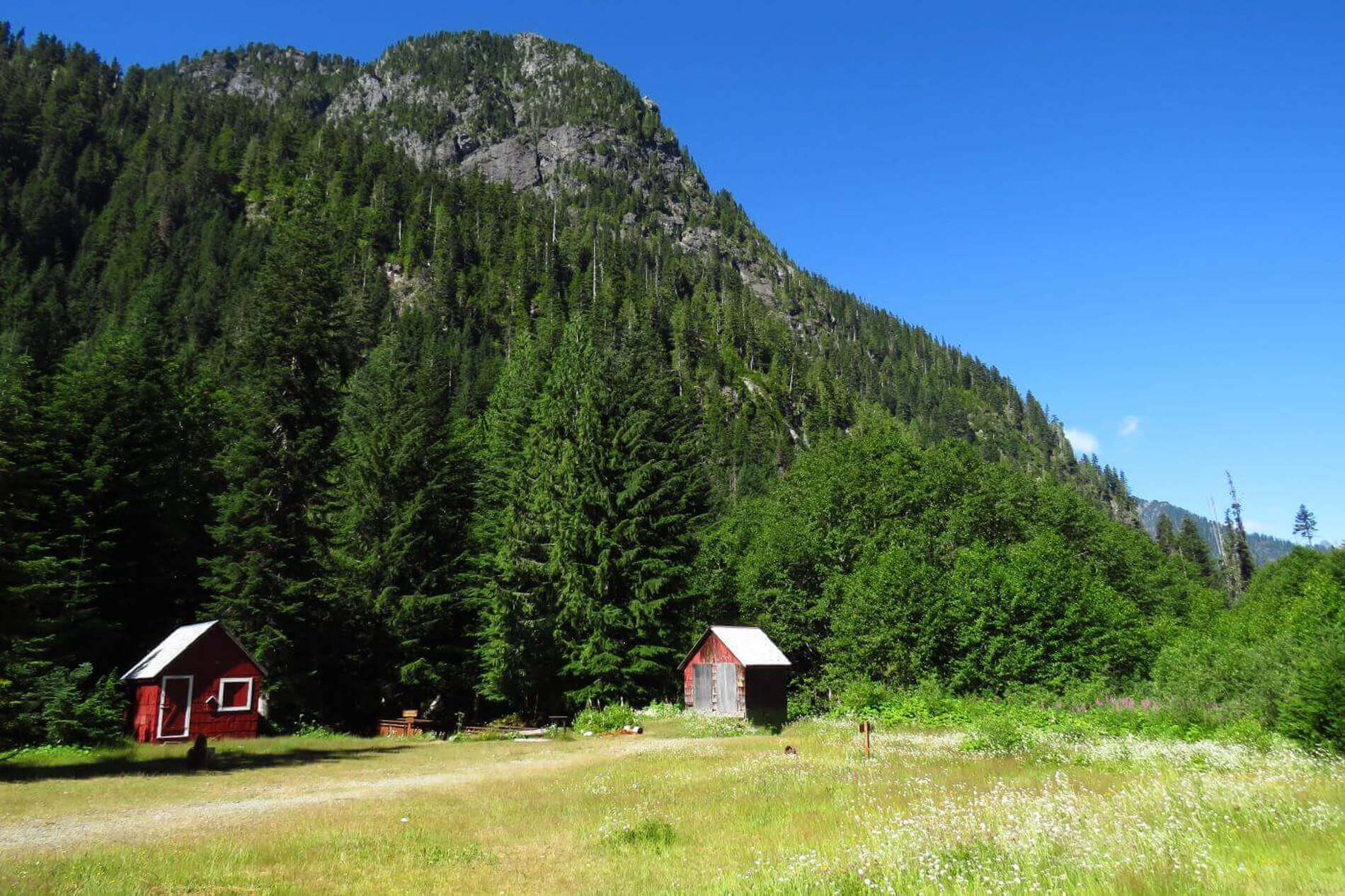 Photo of two red abandoned buildings at the Monte Cristo ghost town in Washington