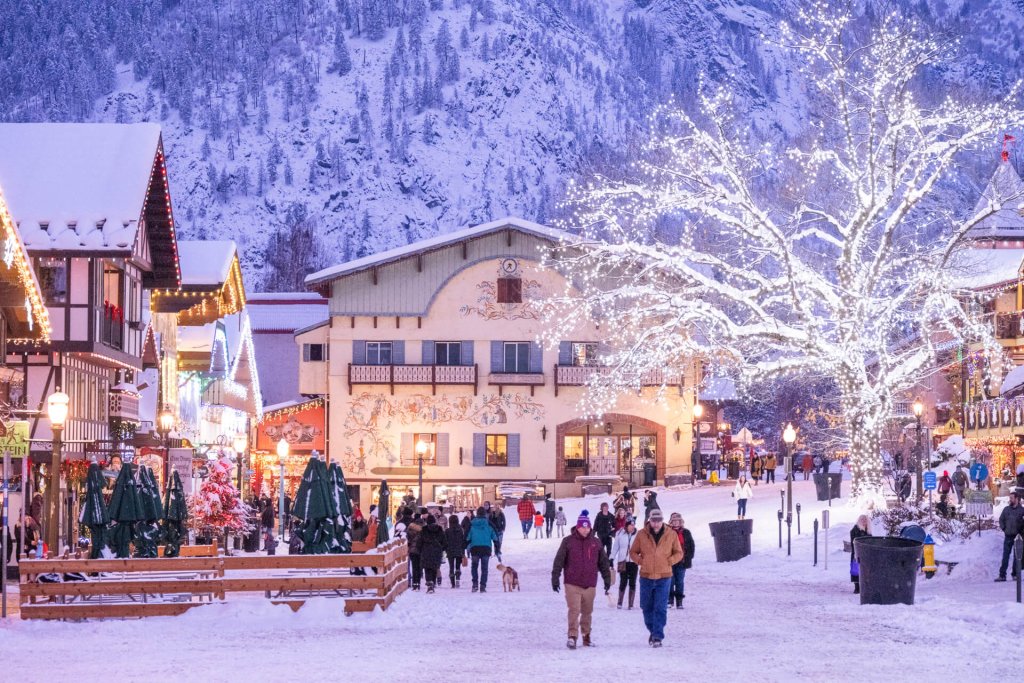 Photo of a snow-covered Leavenworth and lighted trees