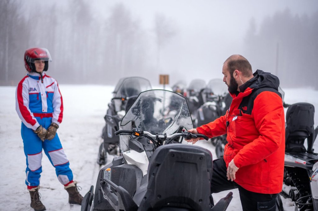 Photo of a snowmobiling guide giving instructions