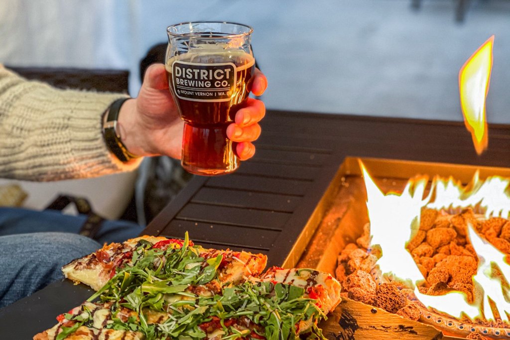 Photo of a hand holding a beer