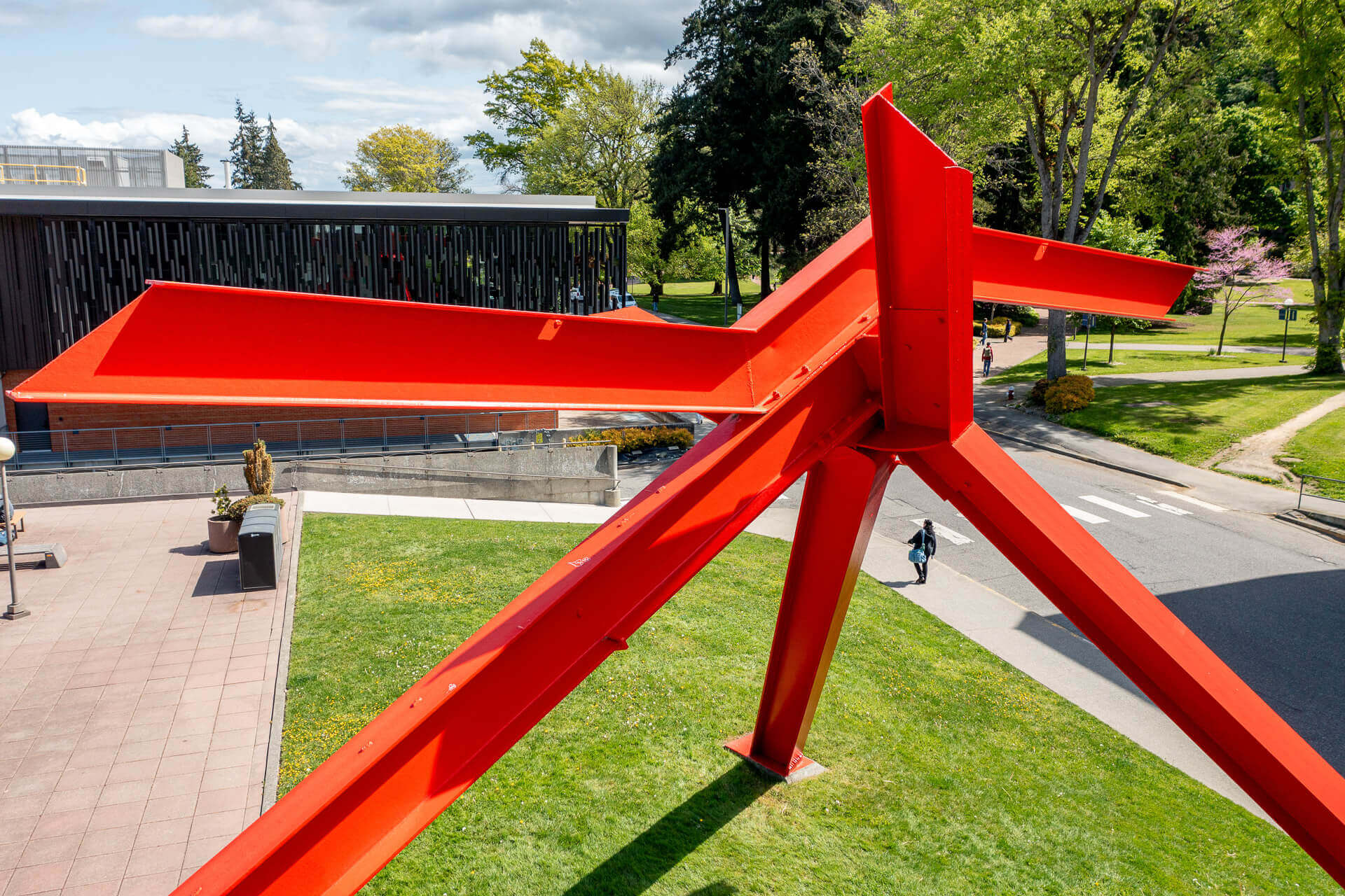 Photo of a bright orange metal sculpture on the WWU campus