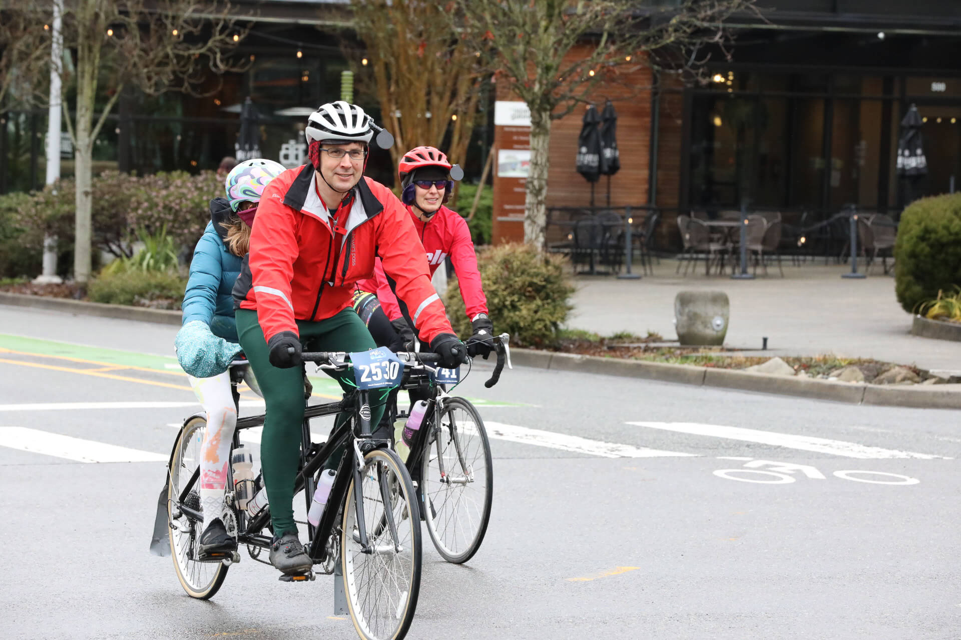 A couple rides a tandem bike during the Chilly Hilly event