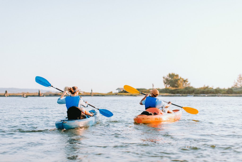 Two people kayak to Jetty Island