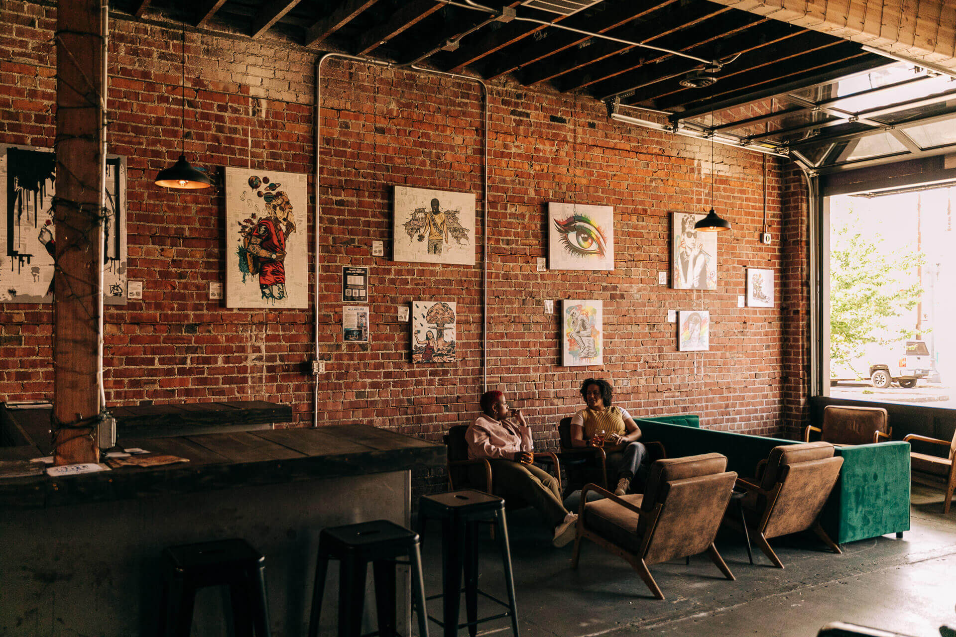 Two women sit in chairs in a brewery in Everett