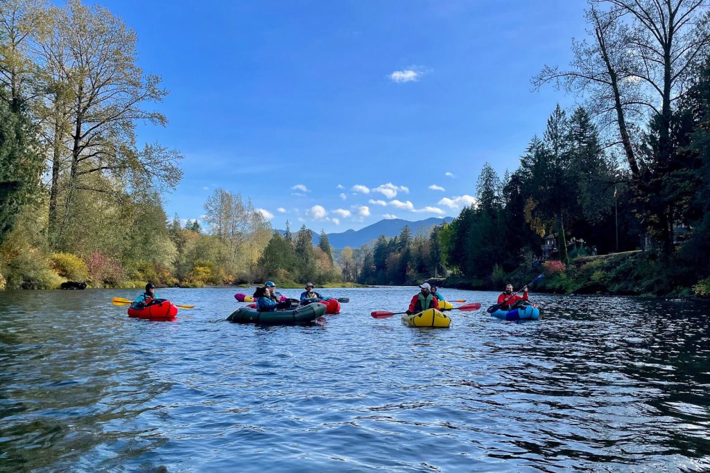 A group of people enjoy river rafting