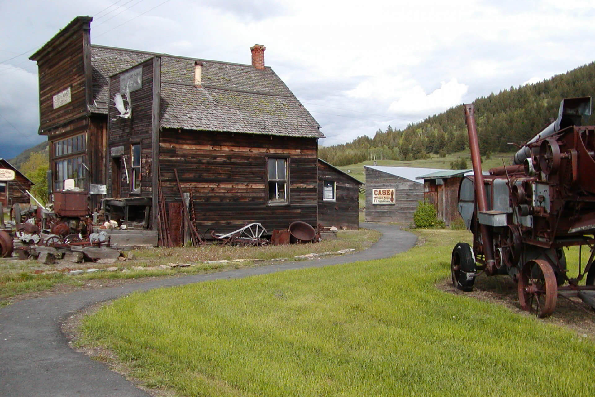 The wooden exterior of a building and old farm equipment