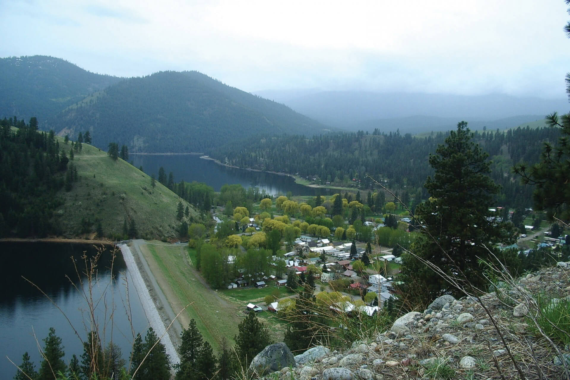 An aerial view of a lake and foothills