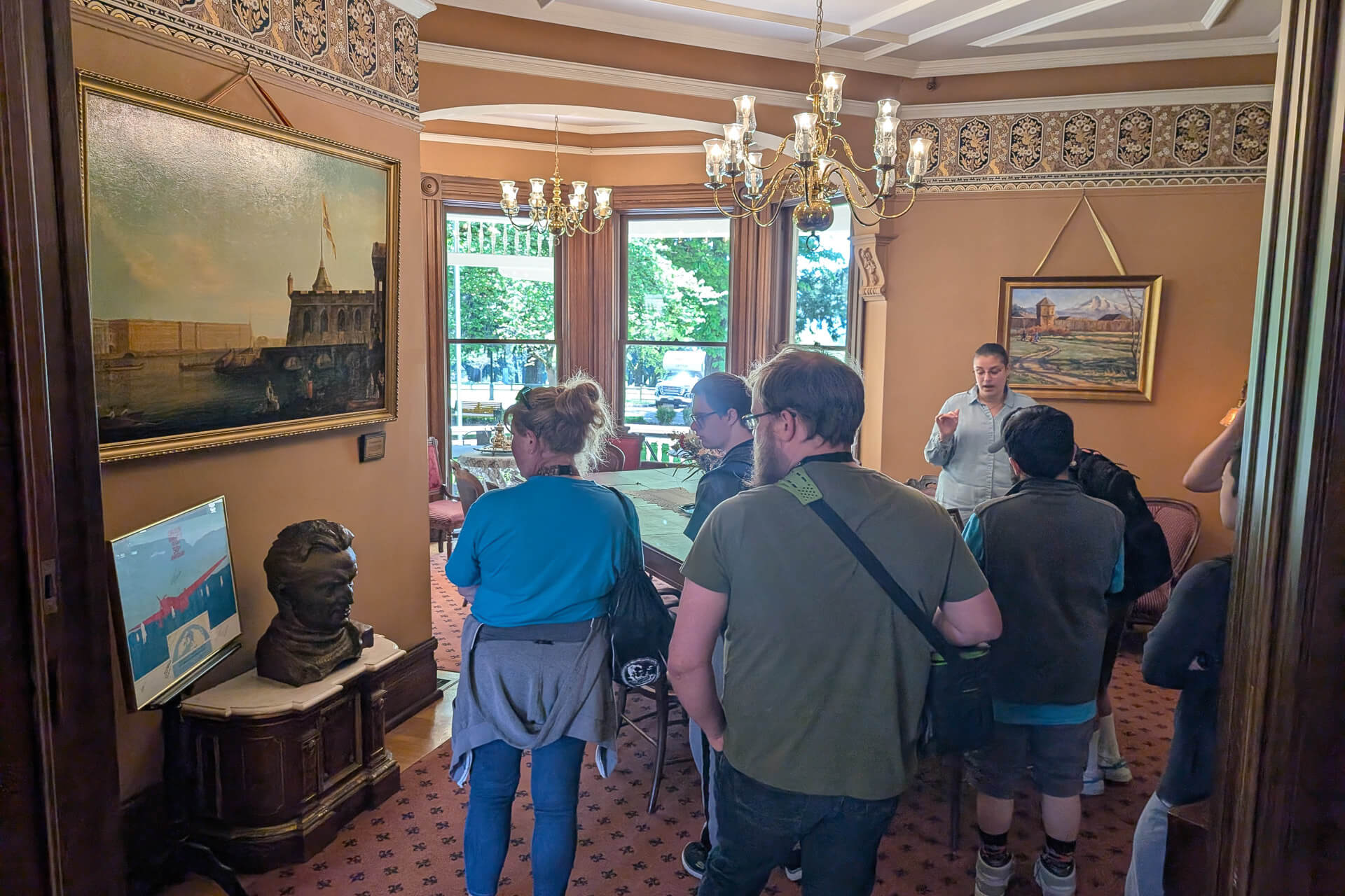A group of people tour the inside of the Marshall House, a historic site in Vancouver WA