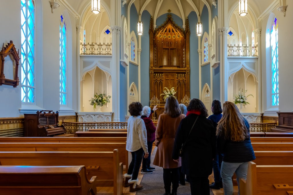 A tour group looks at the inside of a historic chapel in Vancouver 